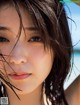A woman with wet hair on the beach. 