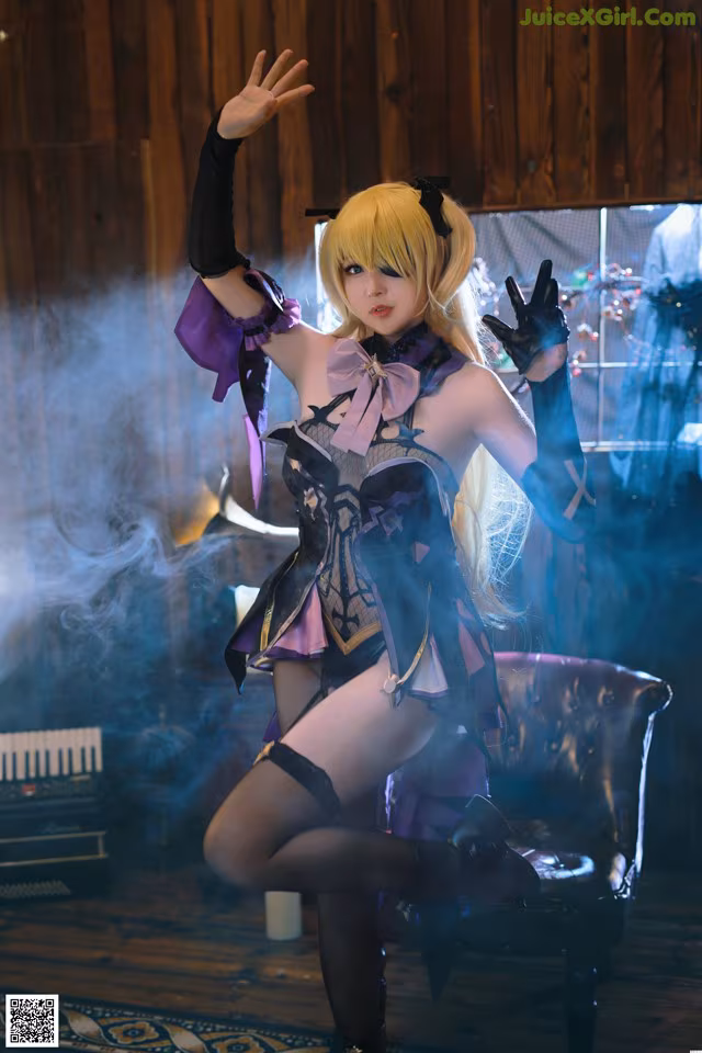 A woman in a black and purple outfit is posing for a picture.