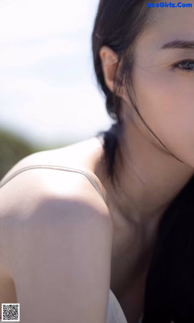 A woman with long black hair is posing for a picture.